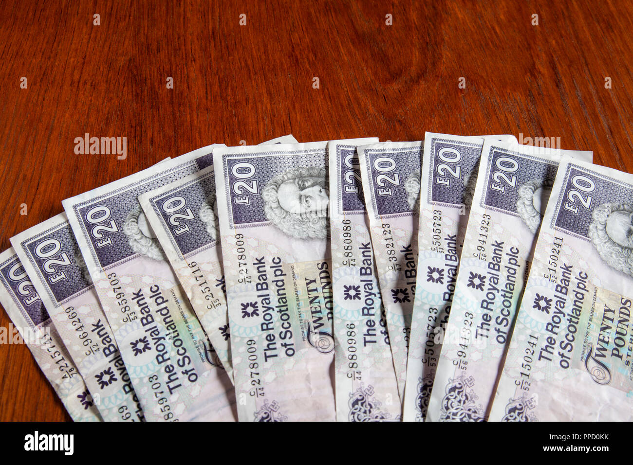 Money left on the table, with copy space. Â£200 sterlilng in used Royal Bank of Scotland Â£20 banknotes. Stock Photo