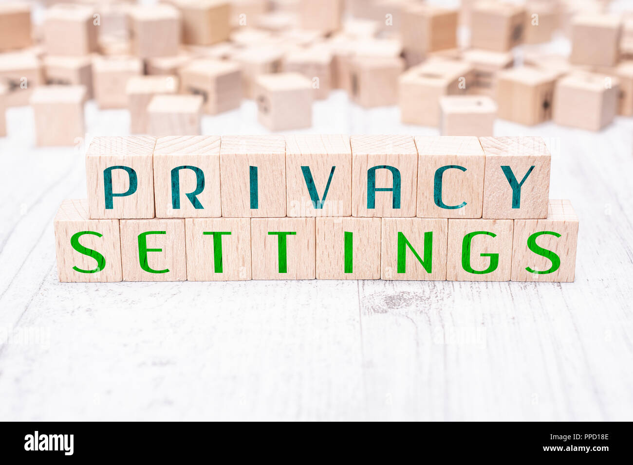 The Words Privacy Settings Formed By Wooden Blocks On A White Table Stock Photo