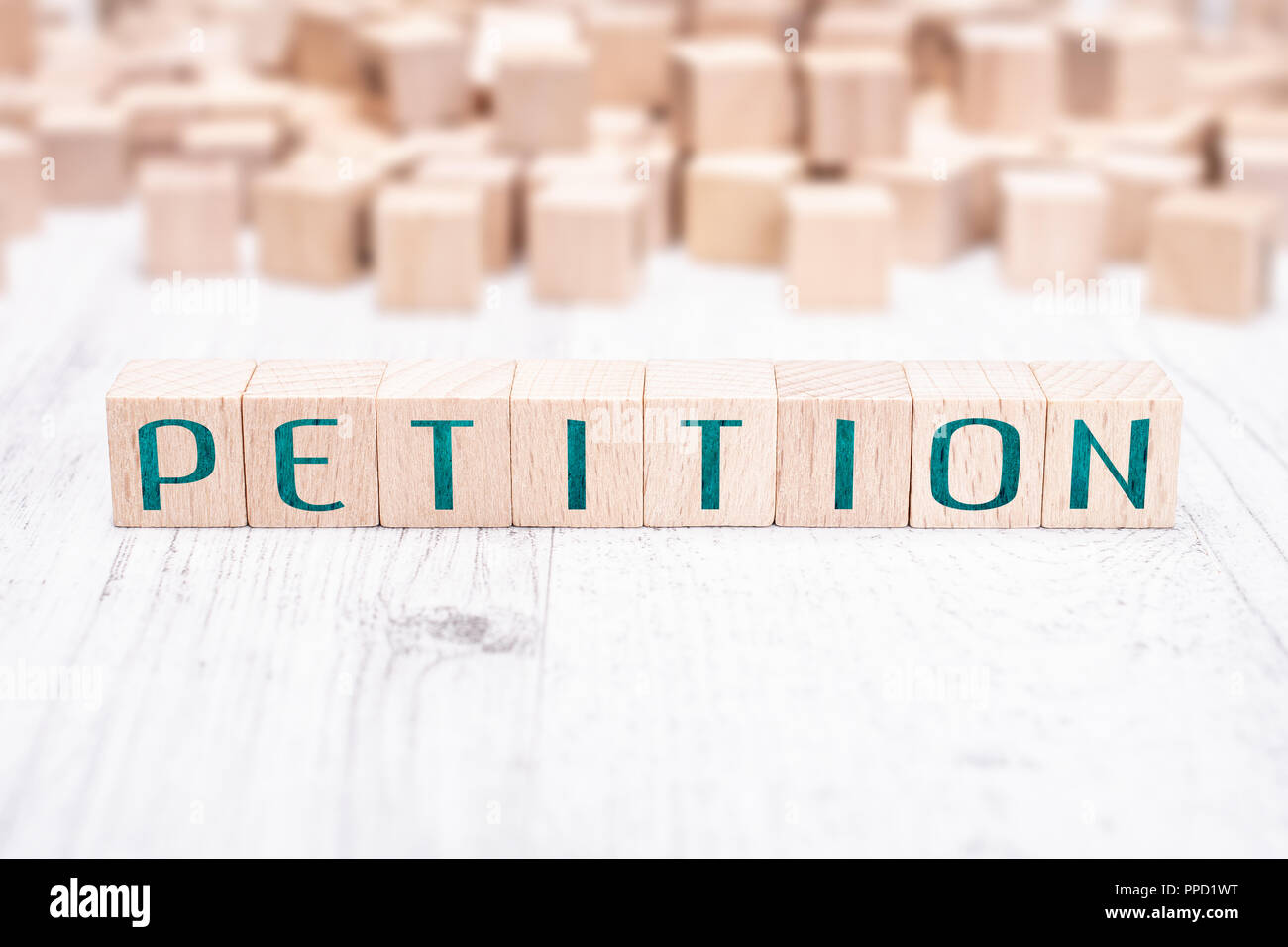 The Word Petition Formed By Wooden Blocks On A White Table Stock Photo