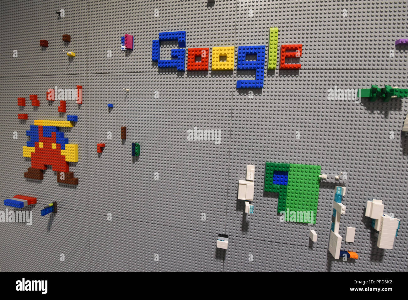 In-house play and relaxation room for employees at the headquarters in Munich. Here is a Lego wall with the logo of Google. Stock Photo