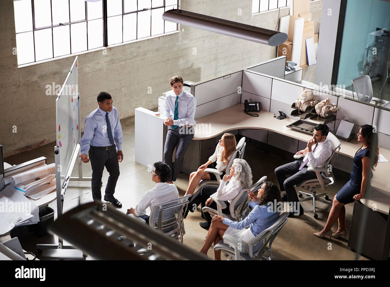 Businessman giving presentation to colleagues, elevated view Stock Photo