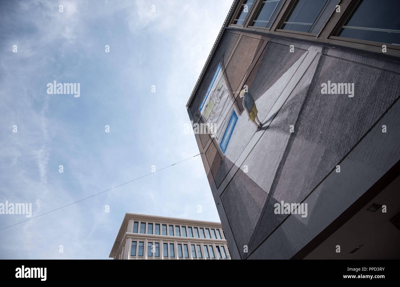 Painting by the Italian street artist 'Blu' on the facade of a vocational school on the corner of Luisenstrasse / Karlstrasse. Stock Photo