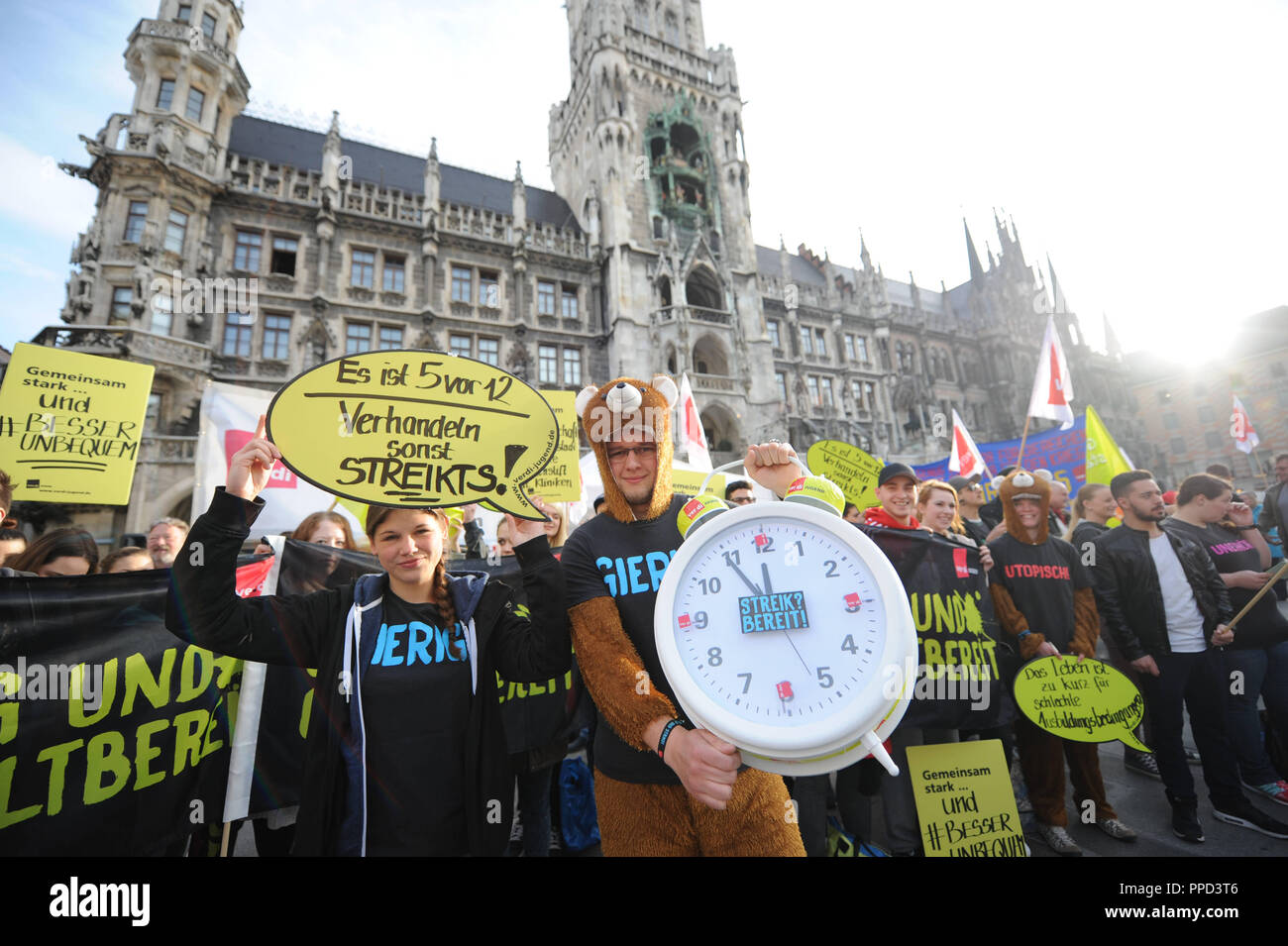 Collective bargaining 2016: Employees from the public sector emphasize their demand for a 6 per cent wage increase with the action 'Wake-up call' on the Marienplatz in front of the Munich Town Hall. Stock Photo