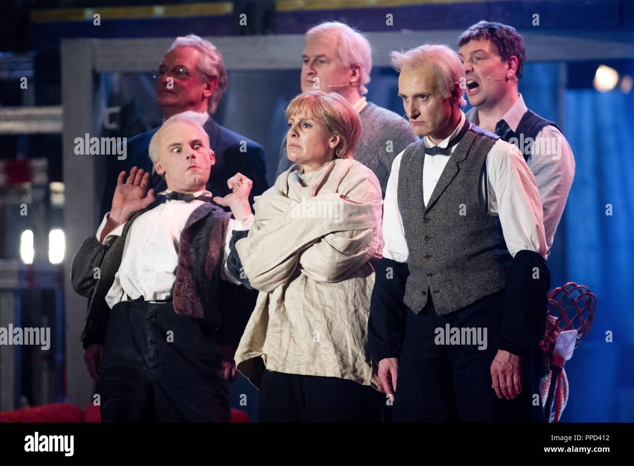 The actors (from left to right) Maxi Scharoth (Mr. Eshofer), Antonia von Romatowski (Angela Merkel) and Paul Kaiser (Oberhirnrat Ueberichhofer) and (behind from left to right) Michael Vogtmann (Joachim Herrmann), Christoph Zrenner (Horst Seehofer) and Stefan Zinner (Markus Soeder ) during the musical comedy at the Starkbierprobe (strong beer tapping) at the Munich Nockherberg. Stock Photo