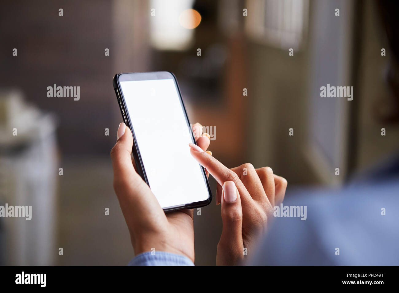 Close up of woman’s hands using smartphone touchscreen Stock Photo