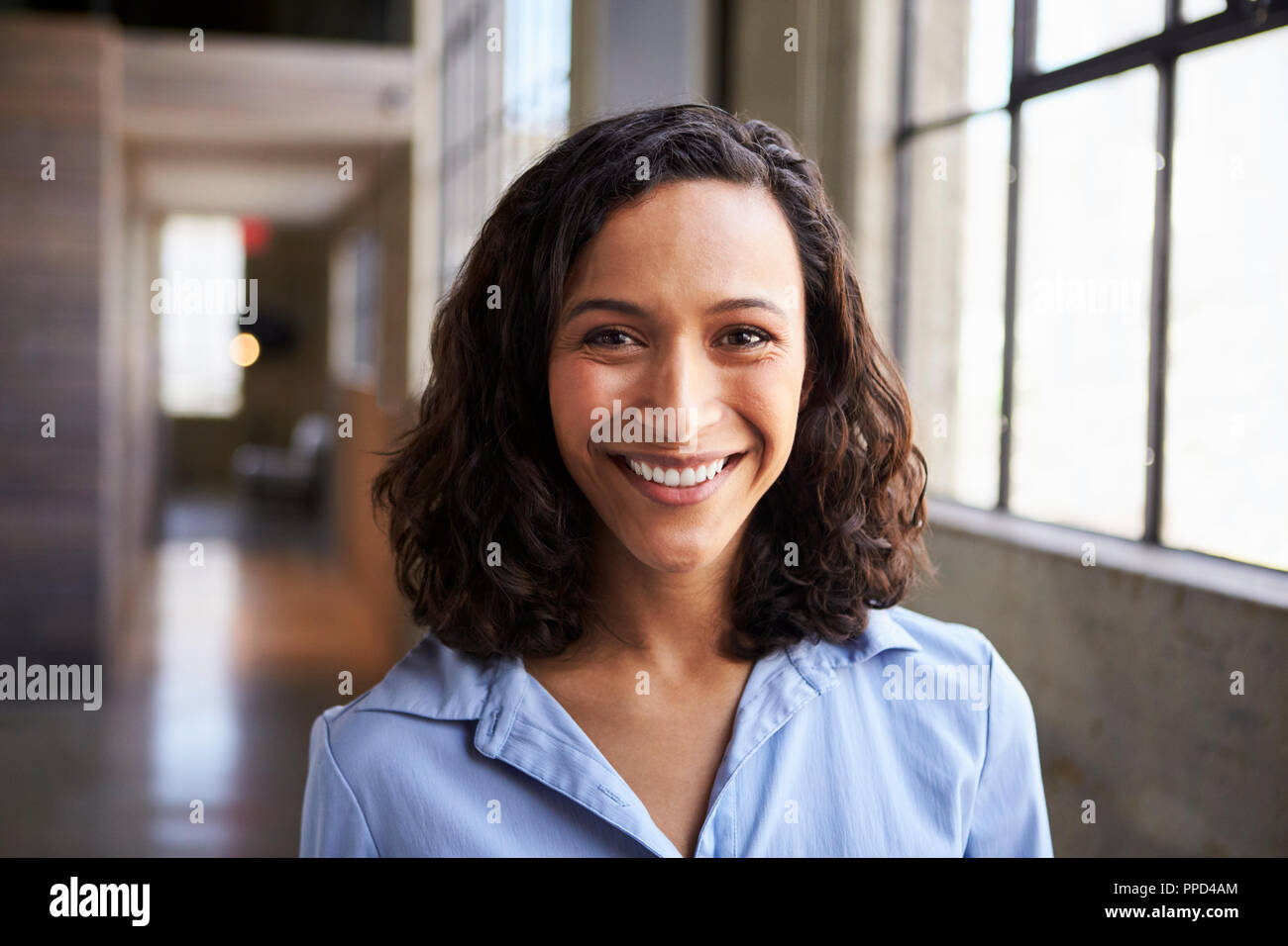 Young mixed race businesswoman smiling to camera Stock Photo