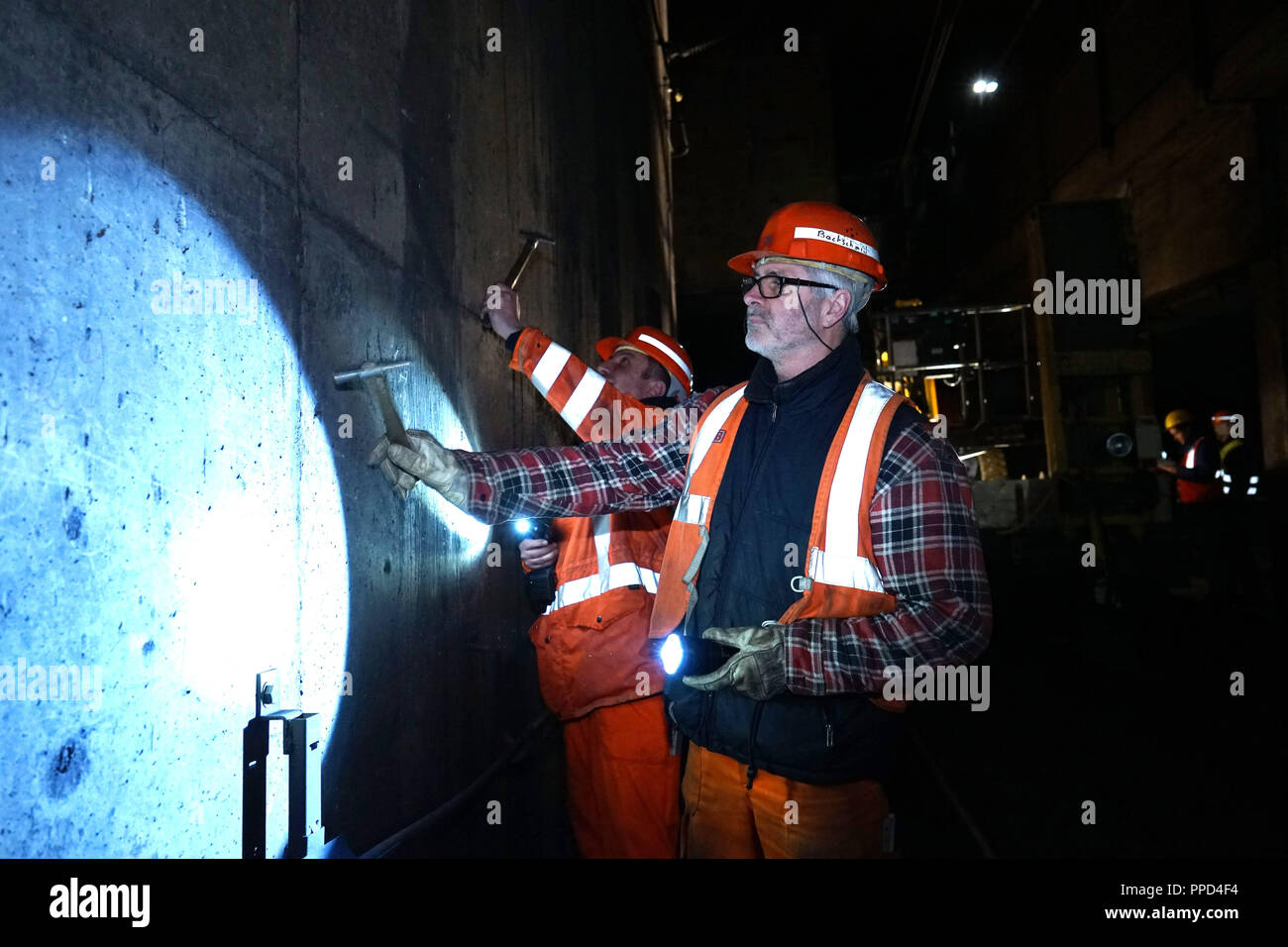 During the nighttime inspection experts of the Munich S-Bahn tunnel look for attrition and damage and mend broken bodies. The photo shows building inspector Erwin Bachschmidt examines a tunnel wall under the Marienplatz. Stock Photo