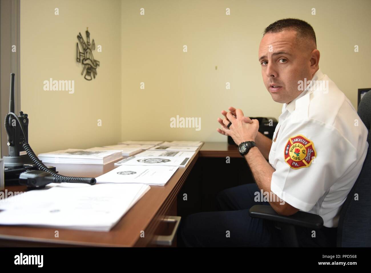 Scott Little, fire chief of Lancaster’s Bureau of Fire, explains various policies and programs that he is working on implementing at the bureau Aug. 21, 2018, Lancaster, Pennsylvania. Little has plans for a number of outreach initiatives, including a citizens’ fire academy, a community engagement program and a youth mentorship program for middle school and high school students. Stock Photo