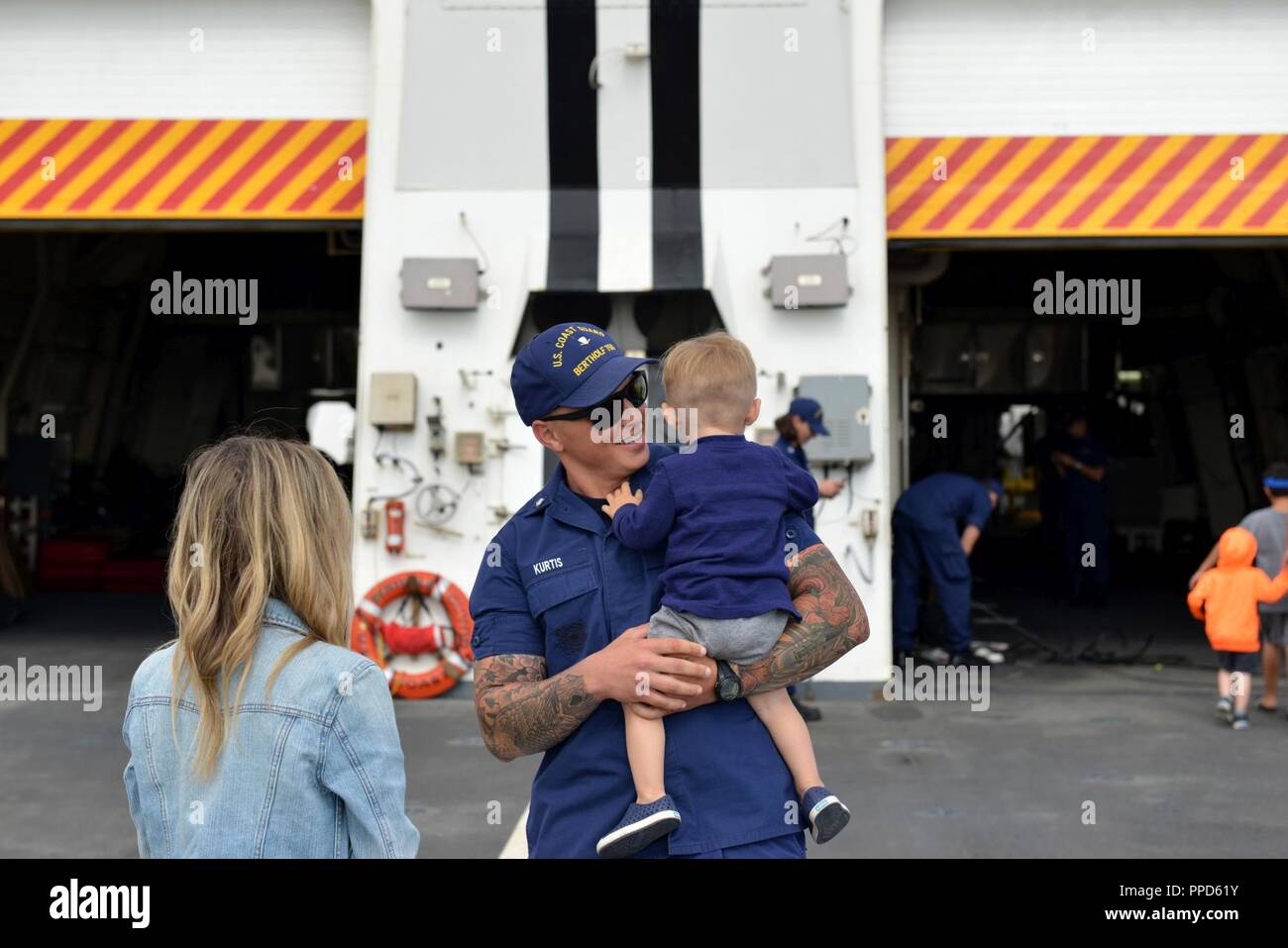 Family and friends reunited following the Coast Guard Cutter Bertholf's return home to Alameda, Calif,. following a 90-day deployment, Sept. 4, 2018. Bertholf is 418-foor National Security Cutter featuring advanced command, control, communication, computers, intelligence, surveillance and reconnaissance equipment; aviation support facilities and a stern cutter boat launch. Stock Photo