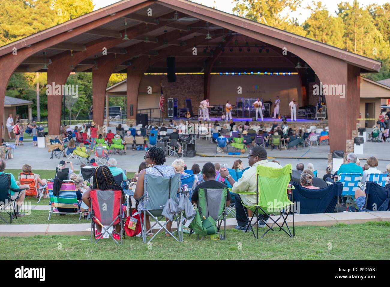 JOHNS CREEK, Ga. (Aug. 31, 2018) Audience members enjoy an outdoor performance by the U.S. Navy Band Country Current at the Mark Burkhalter Amphitheater at Newtown Park in Johns Creek, Georgia. Country Current is on a ten-day tour through Virginia, North Carolina, Georgia and Florida, entertaining audiences while connecting Americans to their Navy. Stock Photo