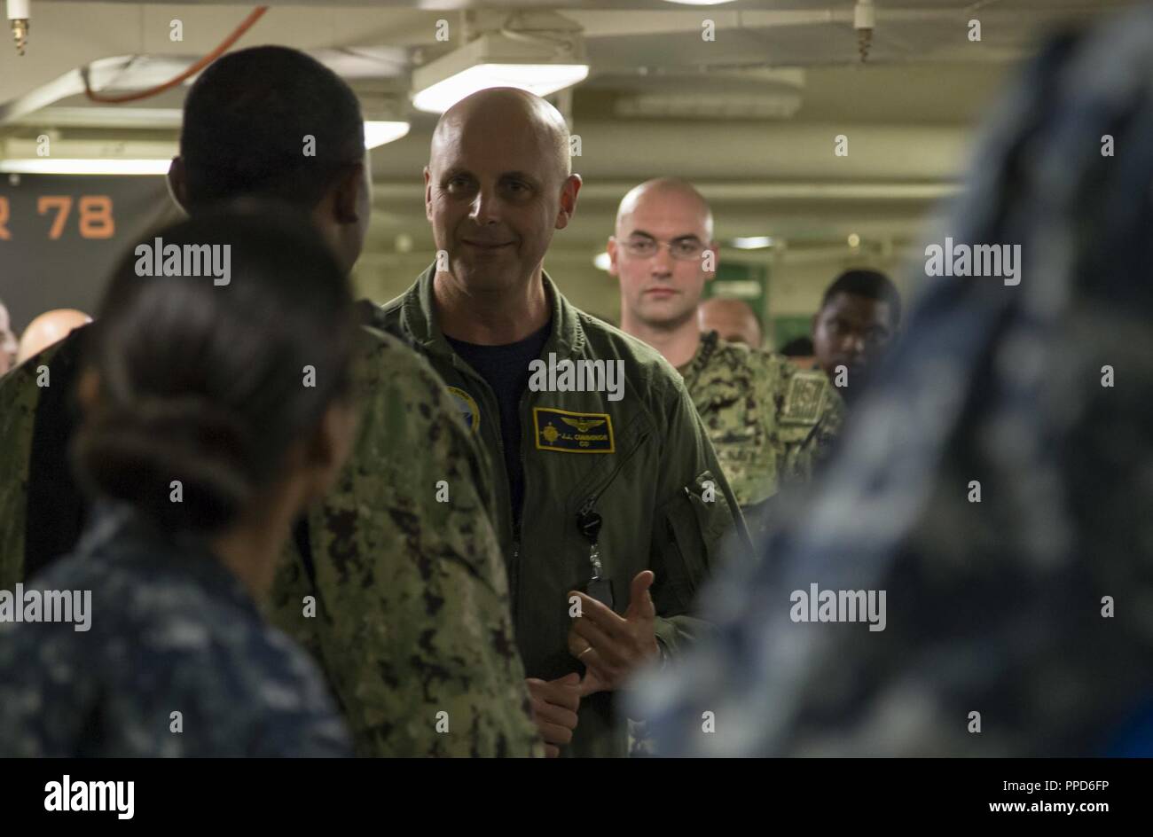 NEWPORT NEWS, Va. (Aug. 23, 2018) Capt. John J. Cummings, USS Gerald R. Ford's (CVN 78) commanding officer, speaks to Aviation Ordnanceman 1st Class Donald Harris, from Tallahassee, Fla., after he was awarded Aviation Ordnanceman of the Year. Harris will be promoted to chief petty officer next month. Stock Photo