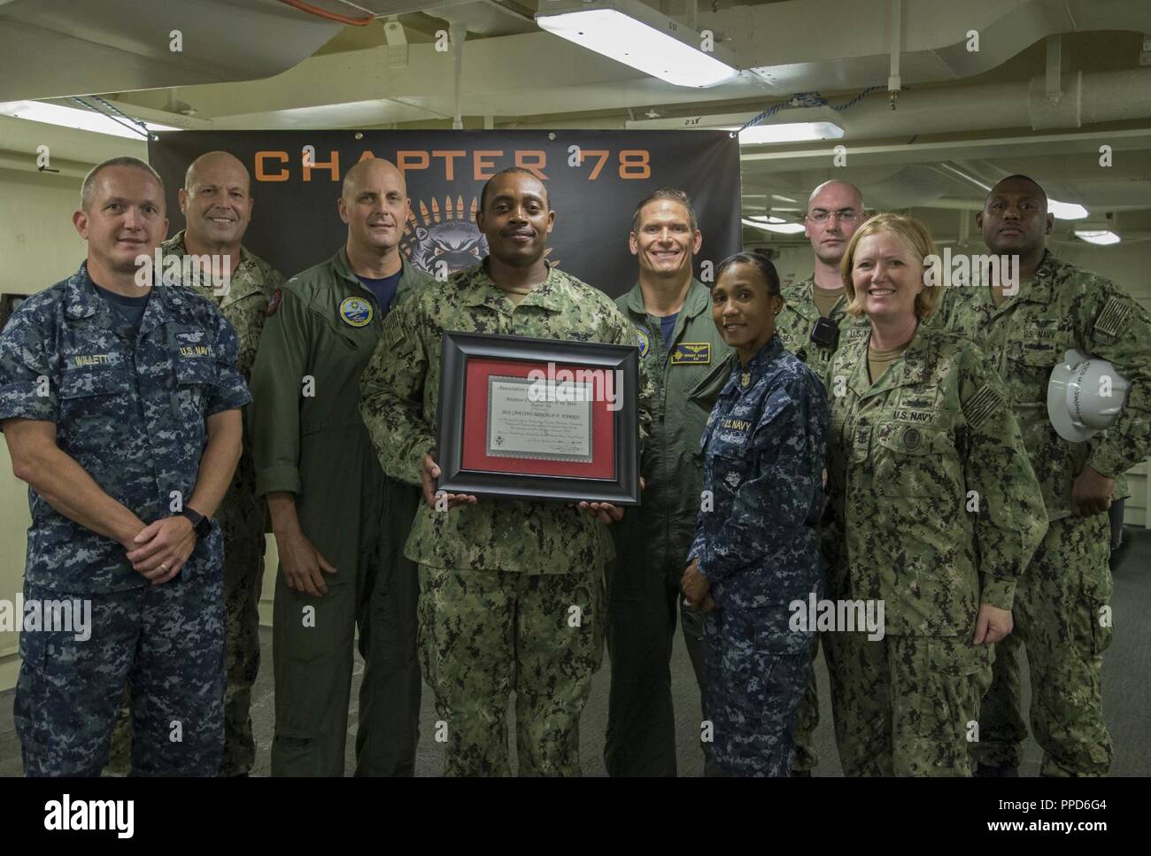 NEWPORT NEWS, Va. (Aug. 23, 2018) Aviation Ordnanceman 1st Class Donald Harris, from Tallahassee, Fla., assigned to USS Gerald R. Ford's (CVN 78) weapons department, center, poses for a group photo after being awarded Aviation Ordnanceman of the Year by Capt. John J. Cummings, Ford's commanding officer. Harris will be promoted to chief petty officer next month. Stock Photo