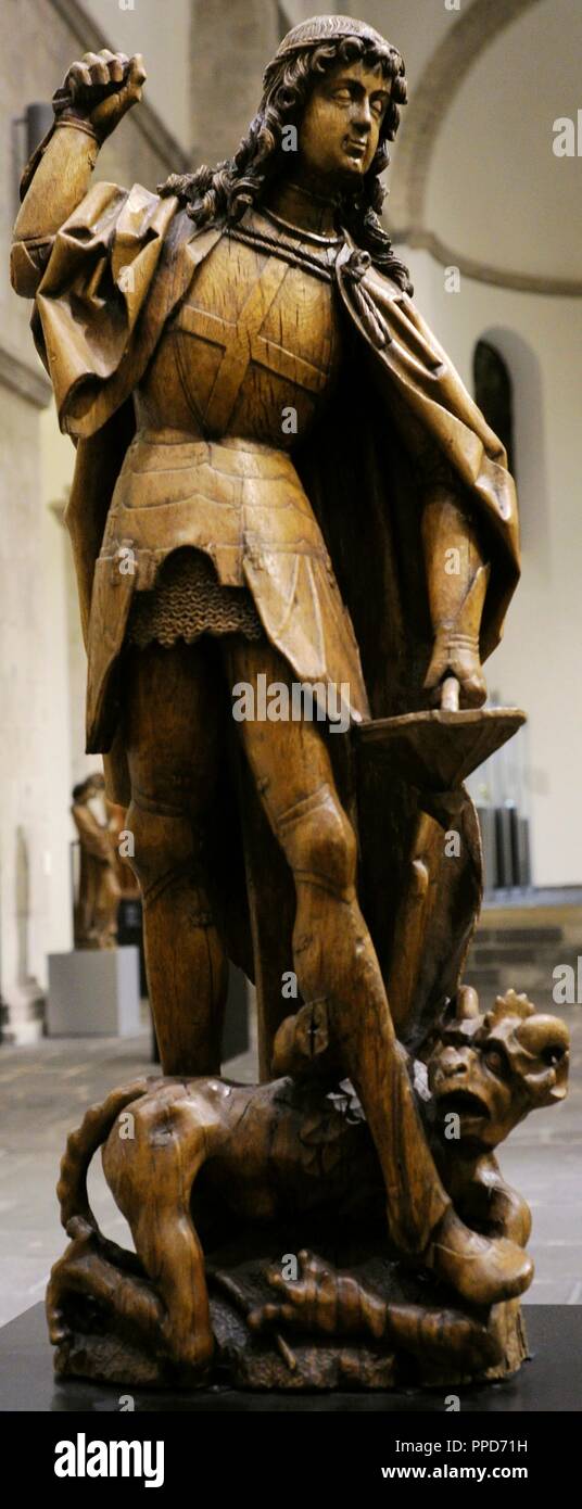 Saint Michael. One of the archangels. Sculpture depicting Saint Michael fighting against Satan. Meuse region, Germany, c. 1500. Oak. Museum Schnu_tgen. Cologne, Germany. Stock Photo