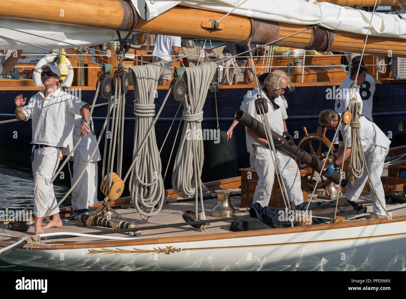 Crew members in action on sailboat moored in the harbour of Imperia during stage of the Classic Yachts Challenge Stock Photo
