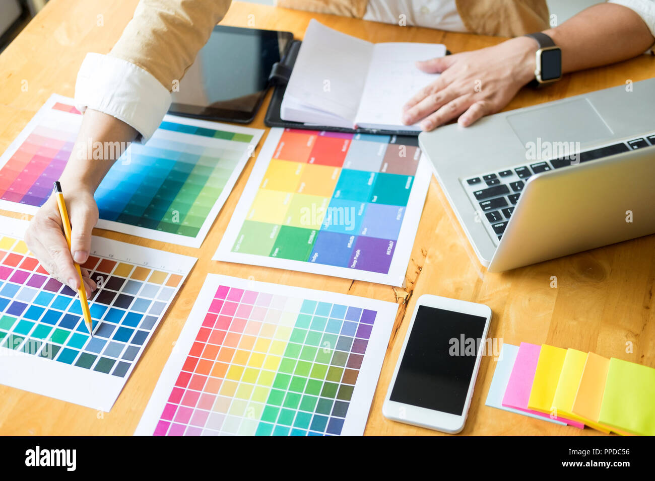 Creative Graphic designer at work. Color swatch samples pantone palette in studio modern office, interior design, renovation and technology concept Stock Photo