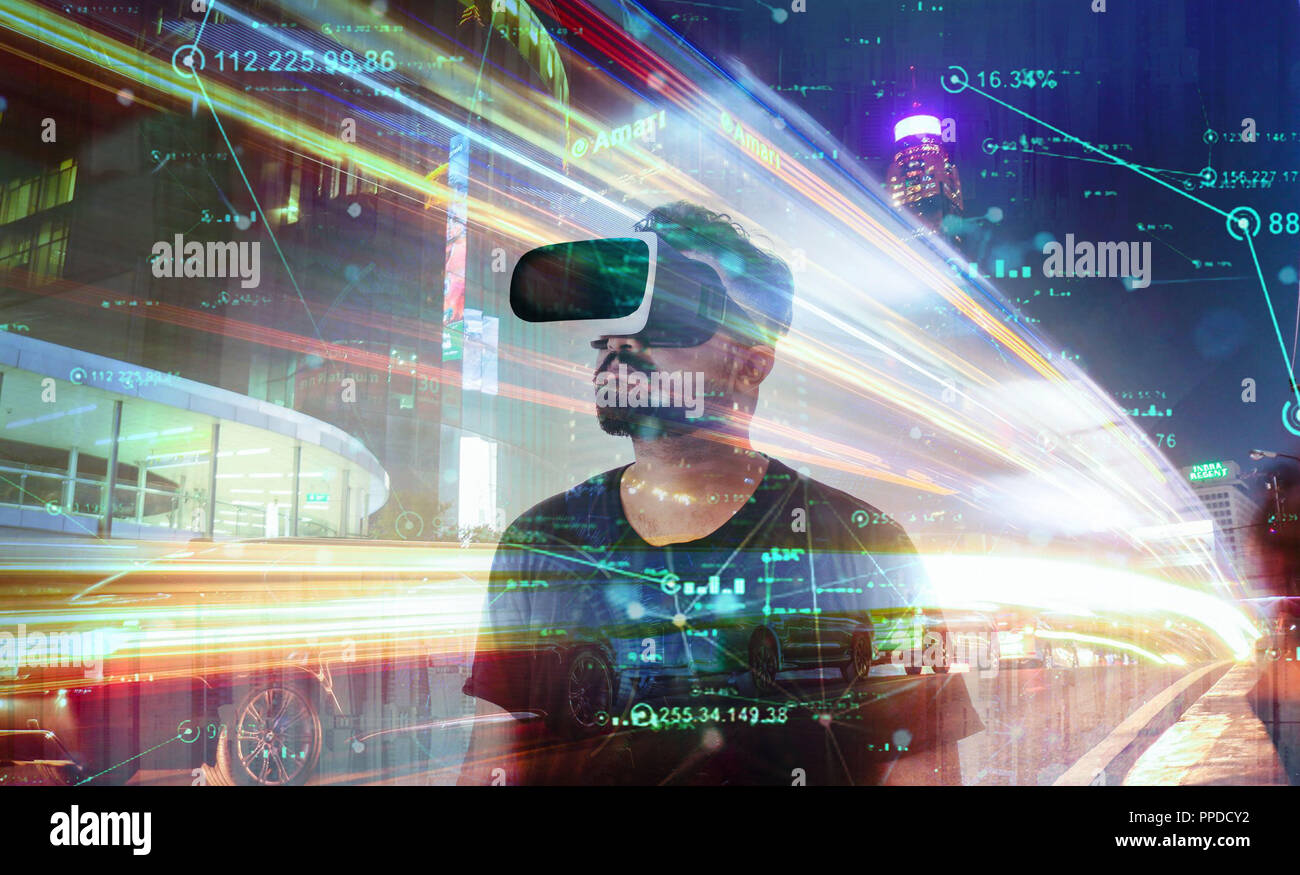 Guy looking through VR (Virtual Reality) glasses - Looking into the Metaverse Stock Photo