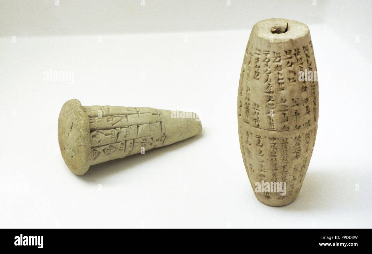 Near East. Mesopotamia. Clay cone with an inscription of Gudea. Lagash. 22nd Century BC. Clay cylinder with an inscription of Nebuchadnezzar II. Babylonia. 6th BC. The State Hermitage Museum. Saint Petersburg. Russia. Stock Photo
