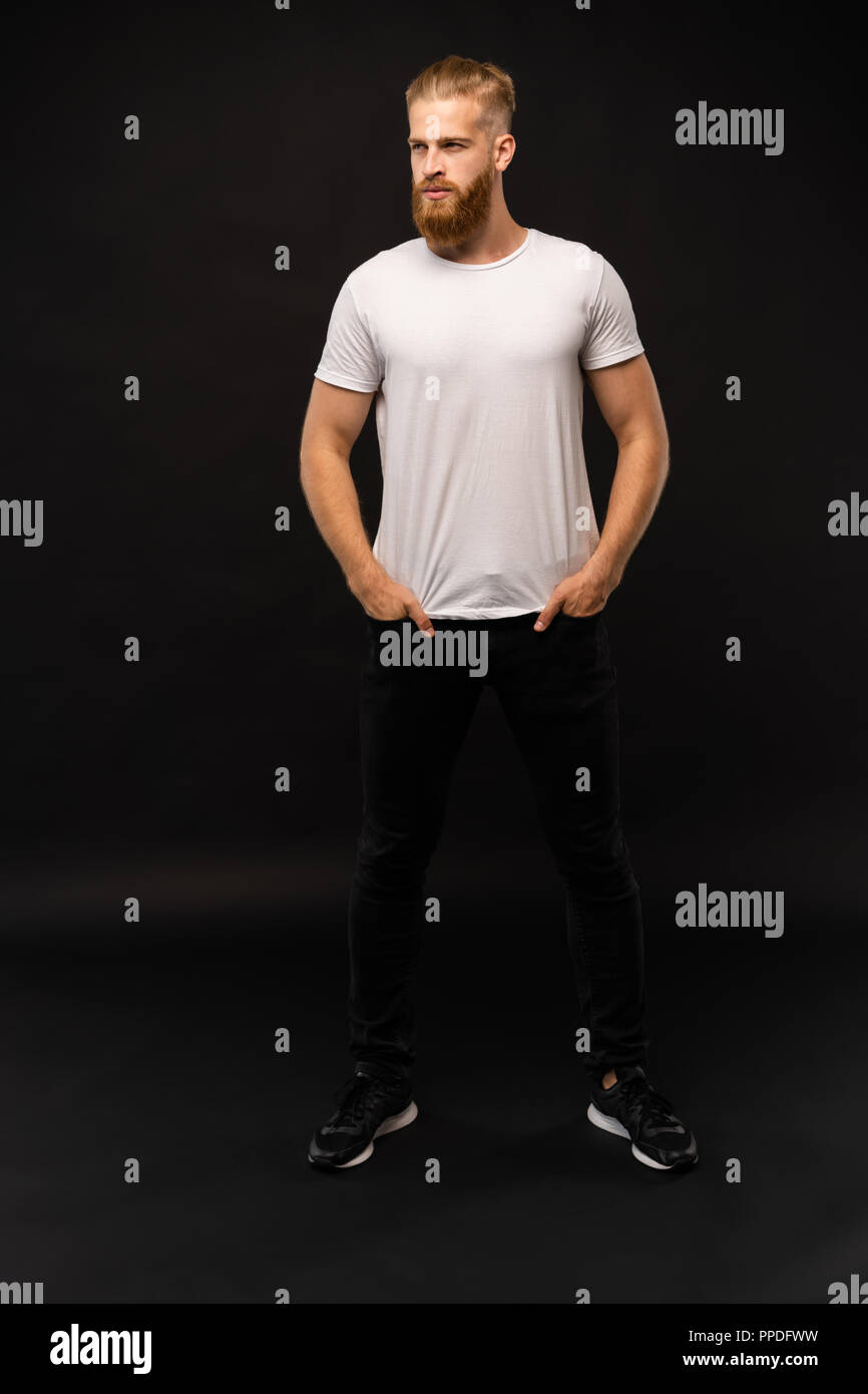 Full length portrait of a happy casual man standing isolated on a gray ...