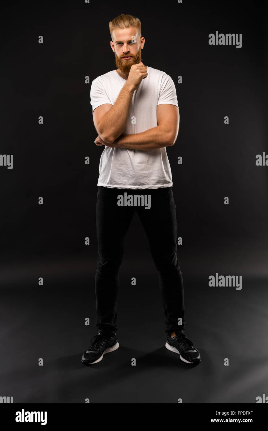 Full length portrait of a happy casual man standing isolated on a gray ...