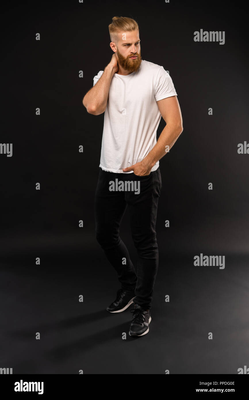 Full length portrait of a happy casual man standing isolated on a gray ...