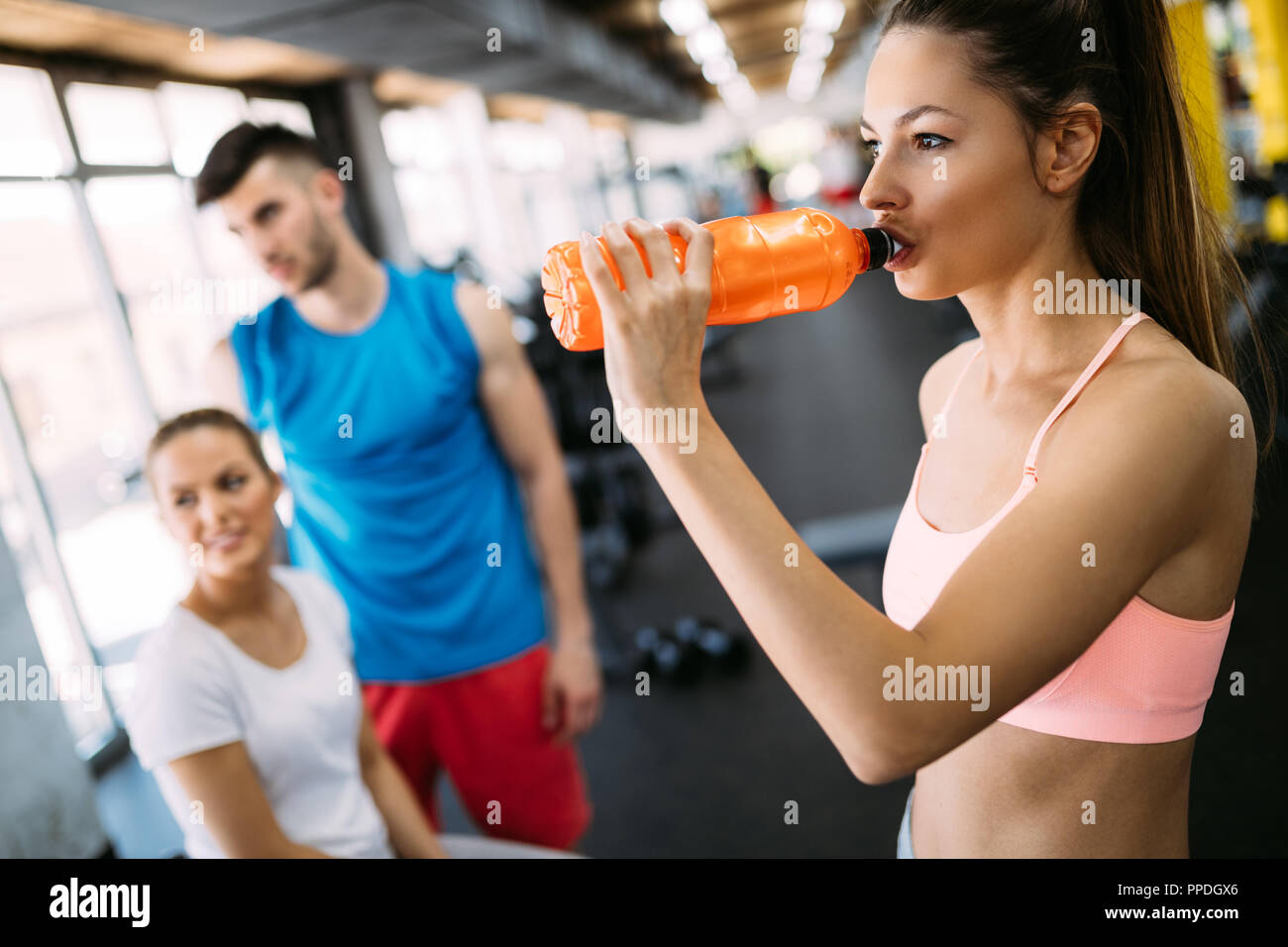 Sporty woman hydrating during workout Stock Photo