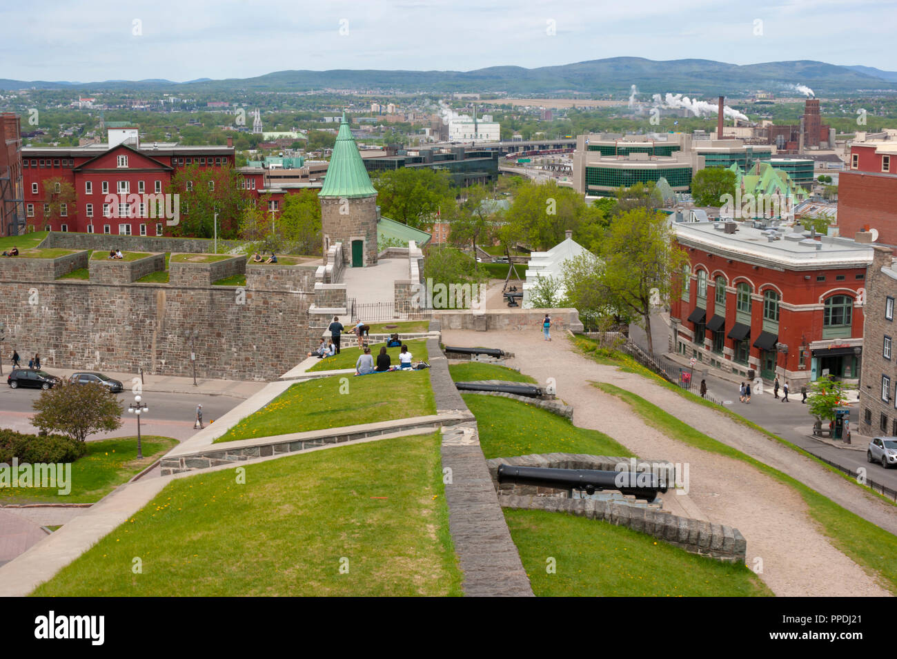 People resting and enjoying a warm day on the Ramparts of Quebec City the fortified city walls