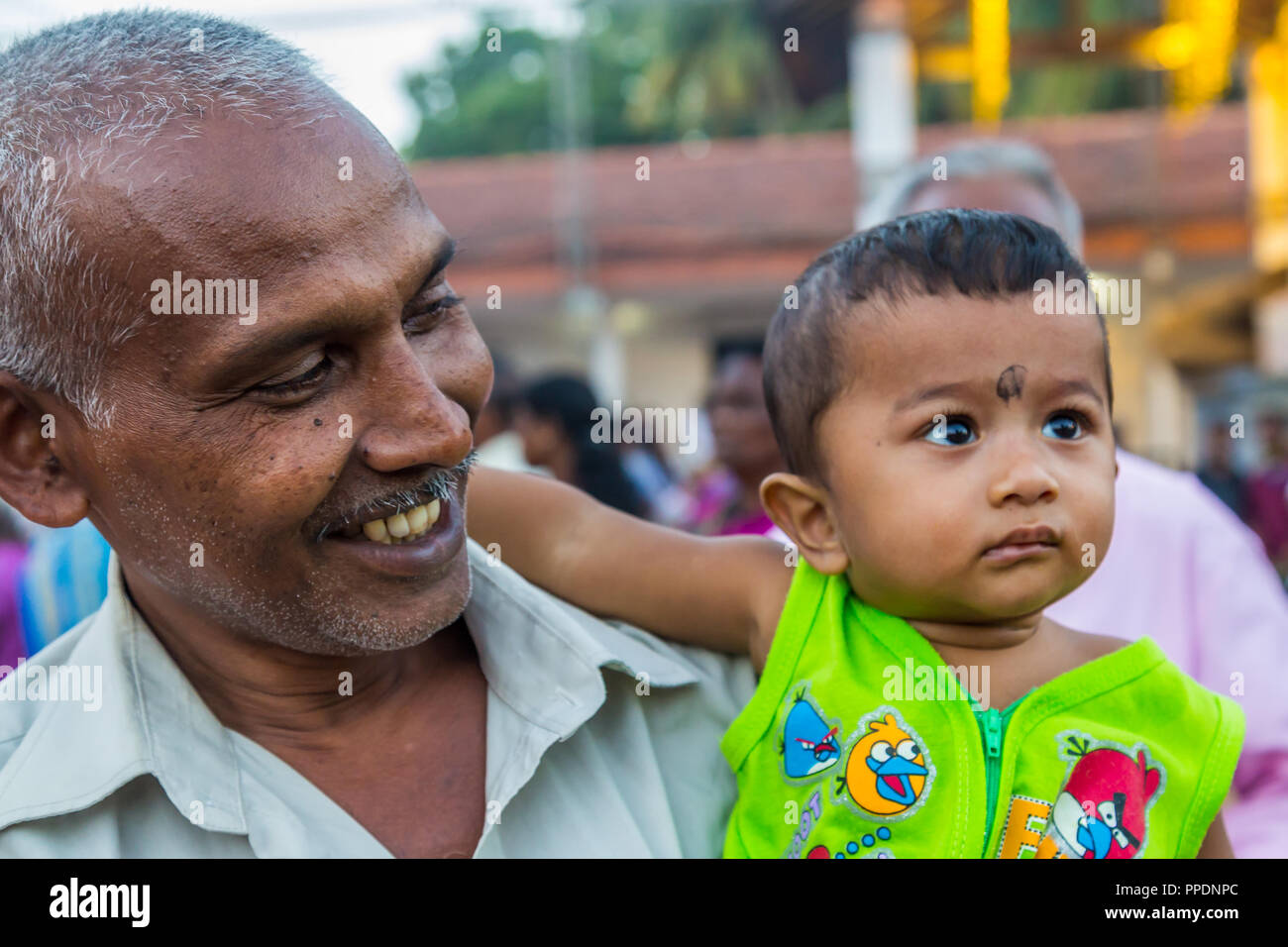 Bandarawela  Sri Lanka August 02 2017 -  HIndu pelgrim with a little baby boy during a celebration in Ruhunu Maha Kataragama Devalaya temple complex i Stock Photo