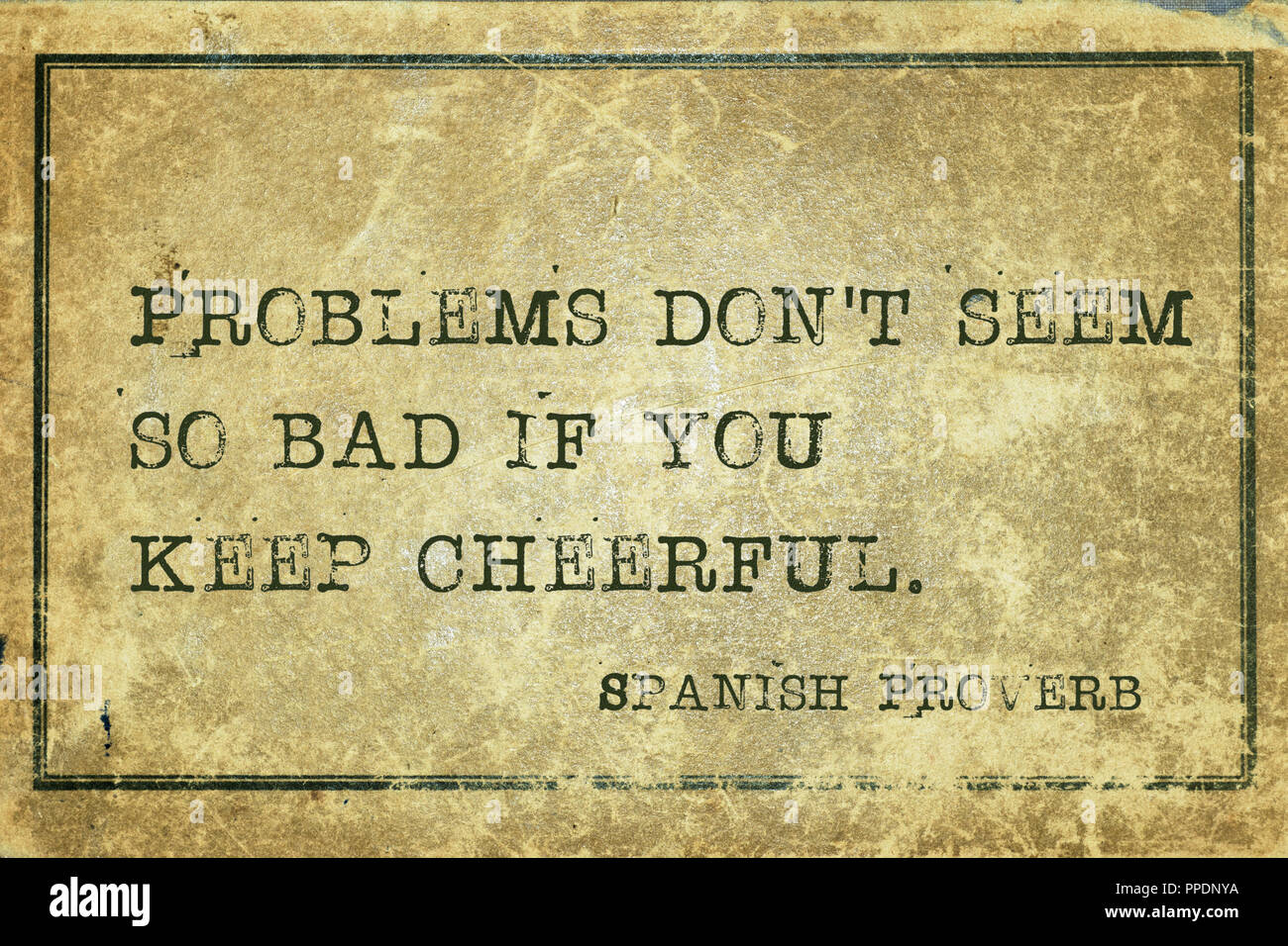 Problems don't seem so bad if you keep cheerful - ancient Spanish proverb printed on grunge vintage cardboard Stock Photo