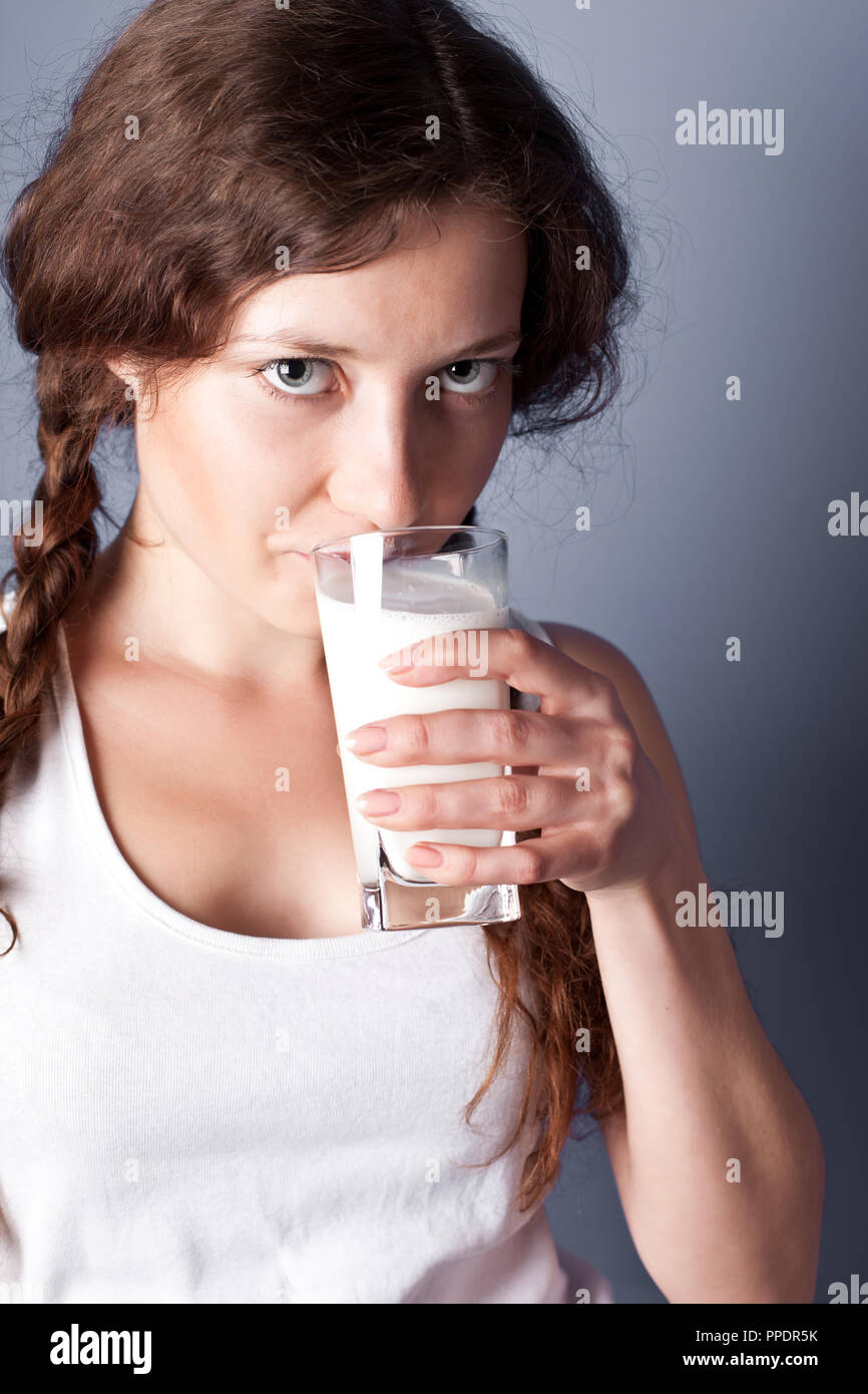 beautiful young woman enjoying a glass milk Stock Photo Alamy