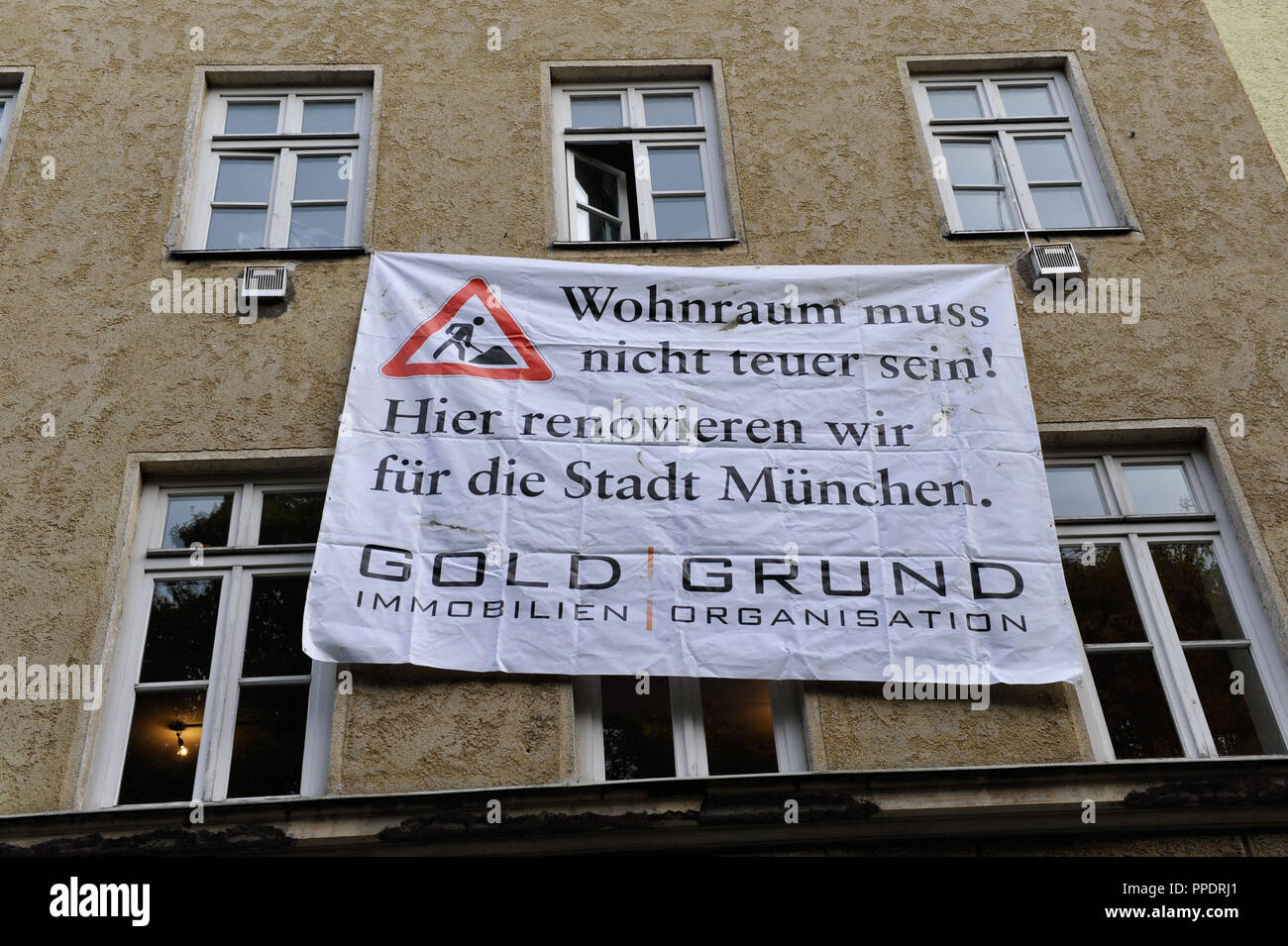 Banner on a symbolically 'occupied' urban house in the Pilotystrasse 8 as part of the Goldgrund campaign for affordable housing. Stock Photo