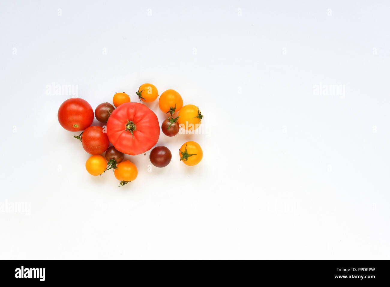 Autumn harvest. Red and yellow tomatoes on a white background Stock ...
