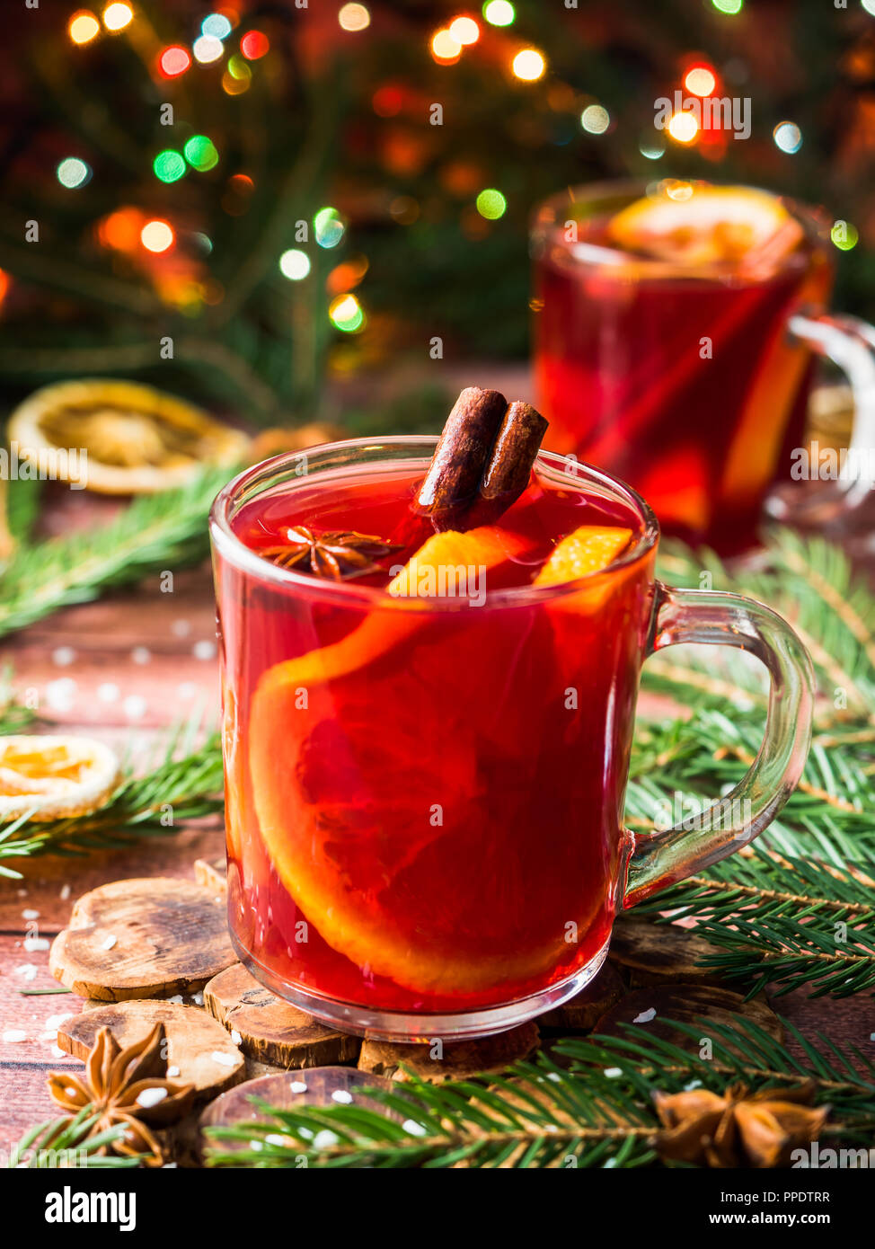 Christmas mulled wine with oranges and spices Christmas decorations with bokeh. Stock Photo