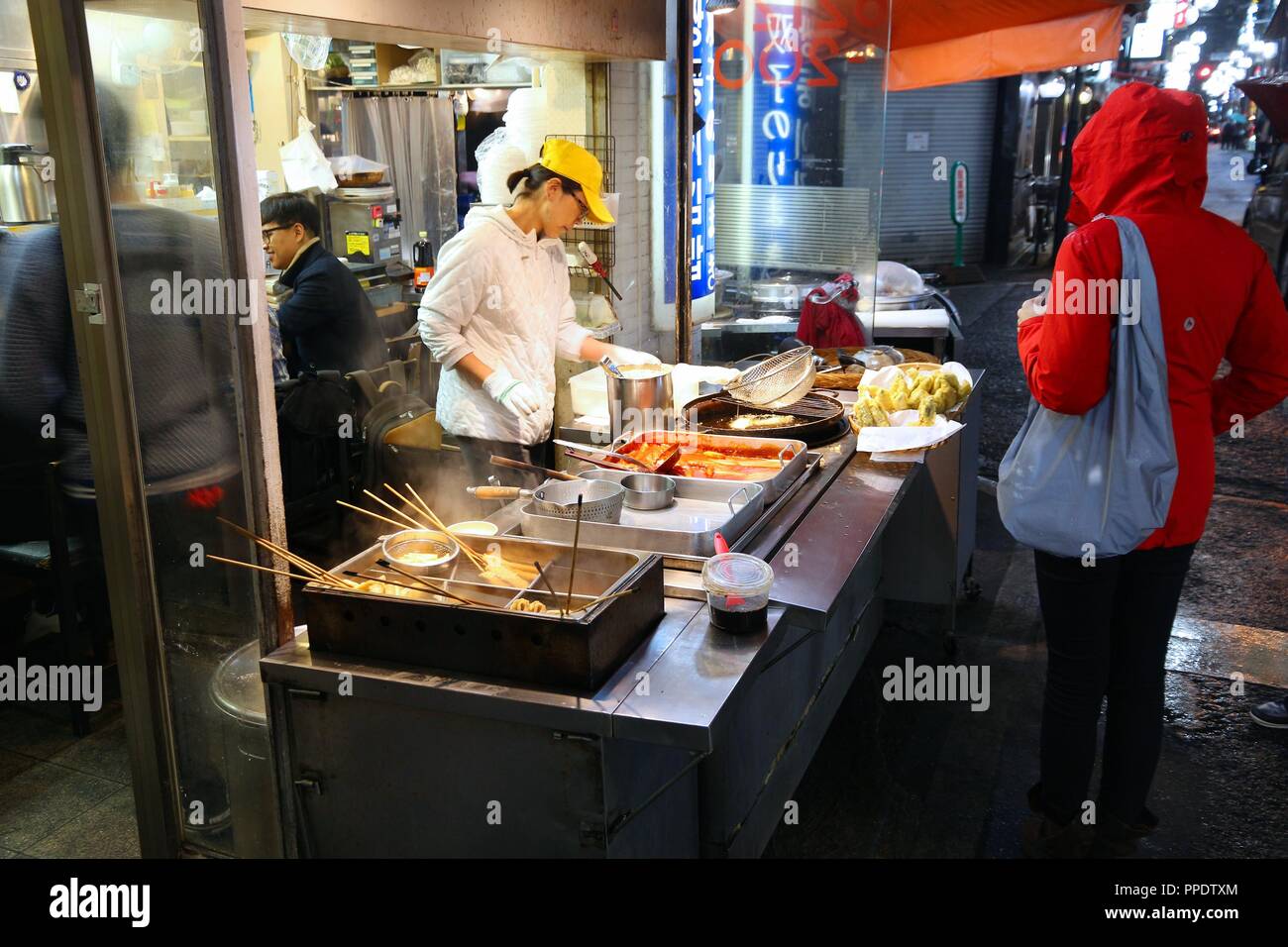 OSAKA, JAPAN - NOVEMBER 21, 2016: Vendor cooks fried street food at Dotonbori street in Osaka, Japan. Dotonbori is the main entertainment area of Osak Stock Photo