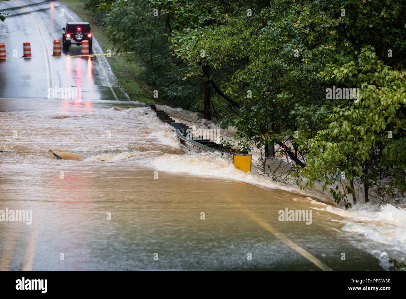Waxhaw, North Carolina September 16, 2018 Motorists are blocked from crossing a road flooded