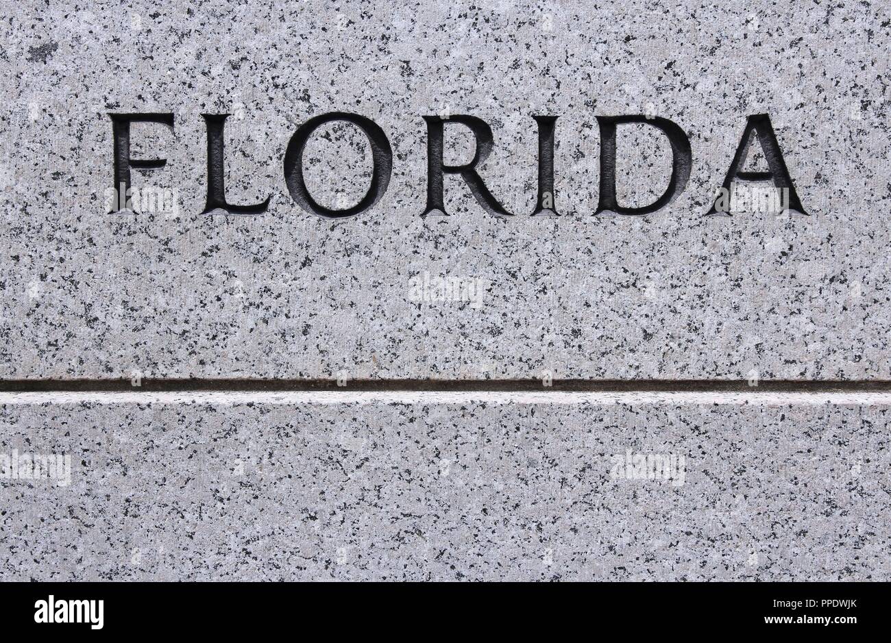 Florida - US state name carved in grey granite stone Stock Photo