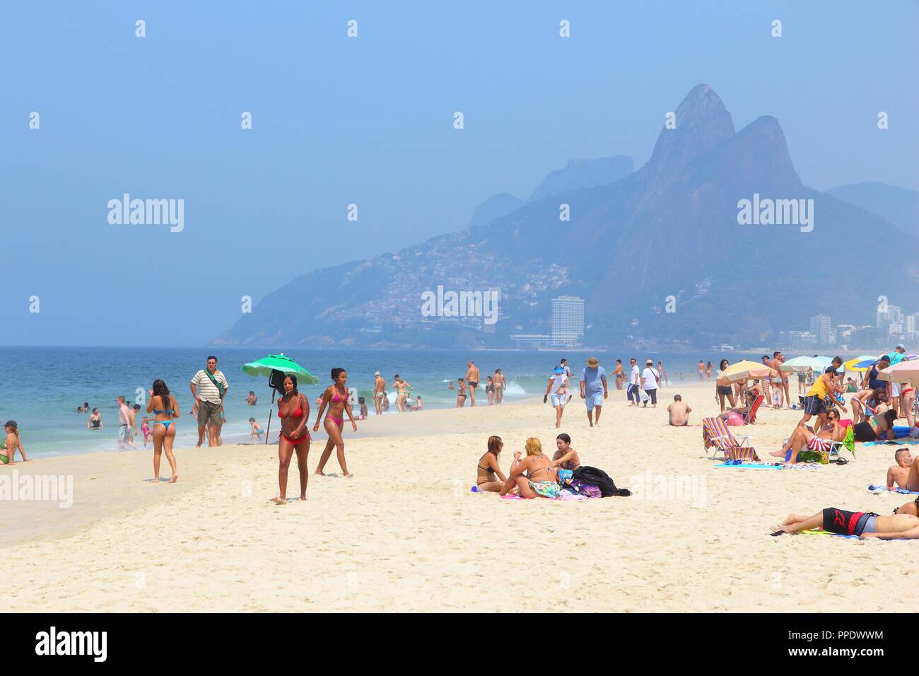 RIO DE JANEIRO, BRAZIL - OCTOBER 19, 2014: People visit Ipanema beach in Rio de Janeiro. In 2013 1.6 million international tourists visited Rio. Stock Photo