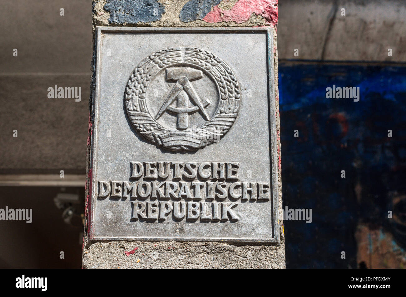 Berlin, Germany - May 28, 2017: The national emblem of the German Democratic Republic or DDR (East Germany) featuring a hammer and a compass, surround Stock Photo