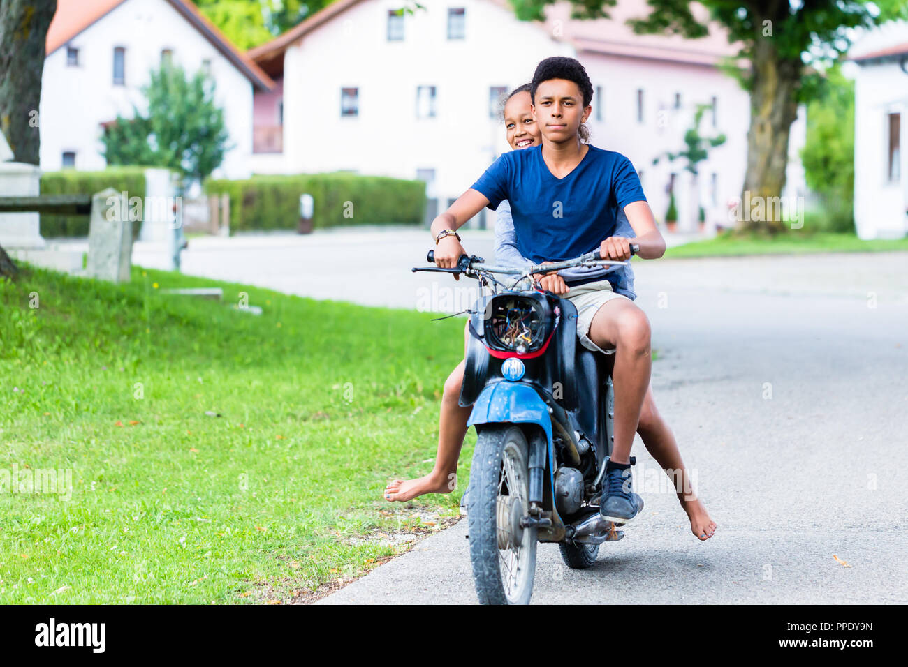 Brother and sister enjoying ride on motorbike Stock Photo Alamy