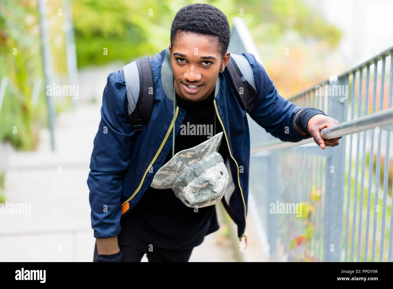 Smiling boy with backpack and hat Stock Photo