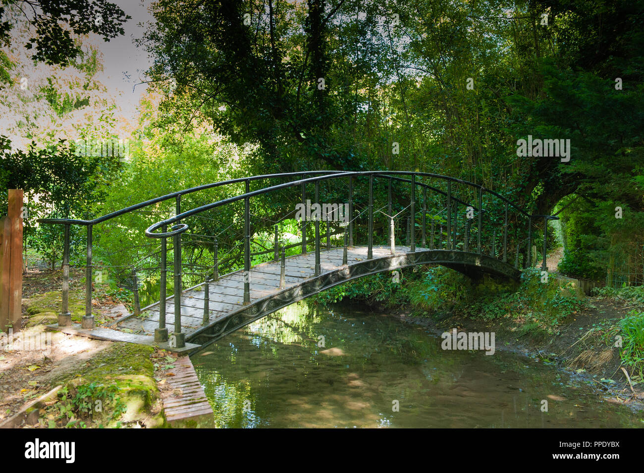 Early 19th century cast iron footbridge over River Wylye in Bishopstrow, Wiltshire, UK. Stock Photo