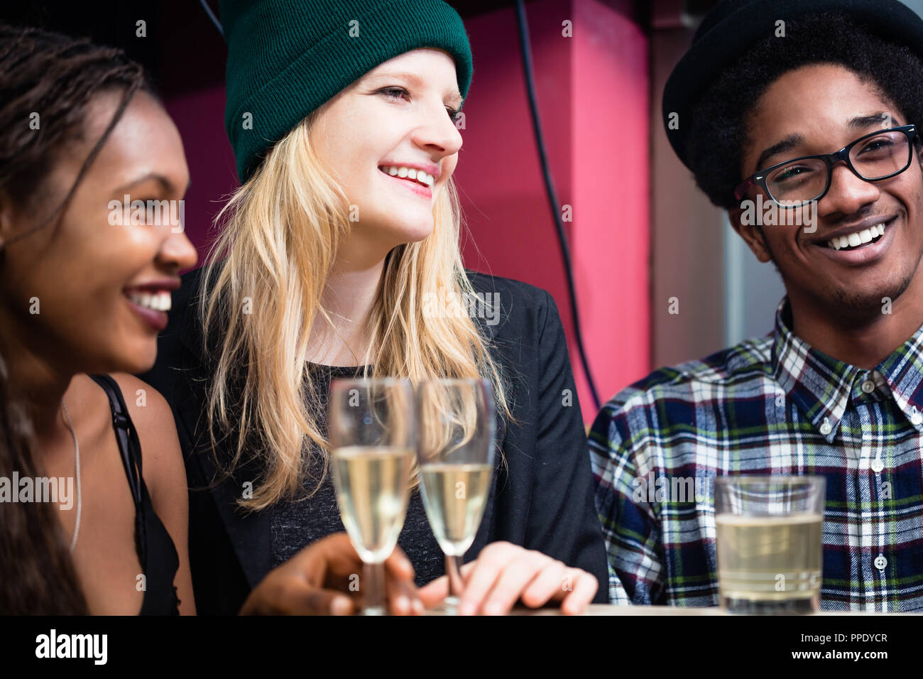 Smiling friends with glasses of evening drinks Stock Photo