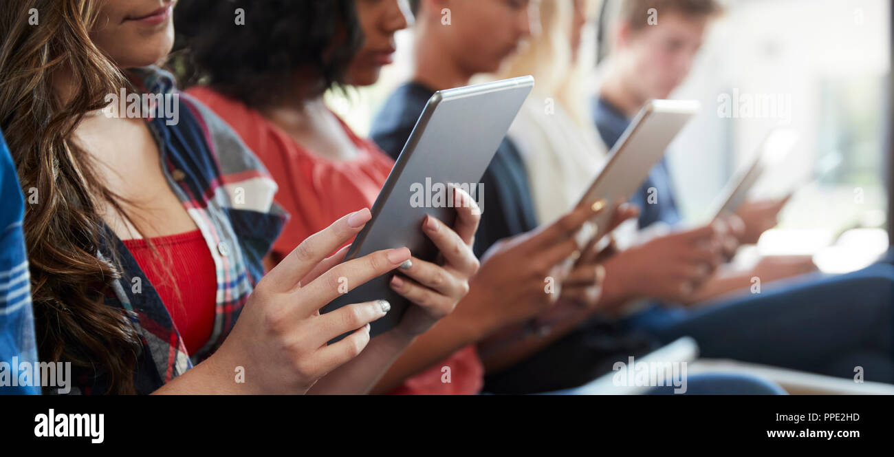 Close Up Of A Line Of High School Students Using Digital Tablets Stock Photo