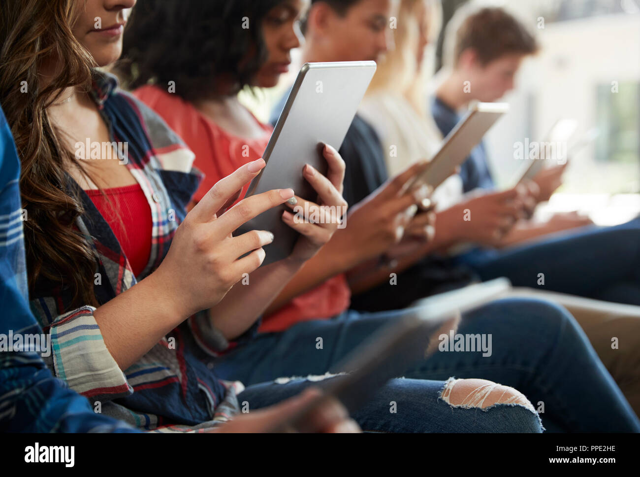 Close Up Of A Line Of High School Students Using Digital Tablets Stock Photo