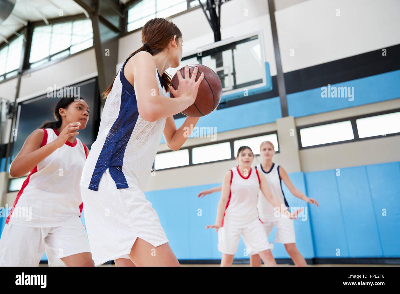 Female High School Basketball Team Passing Ball On Court Stock Photo