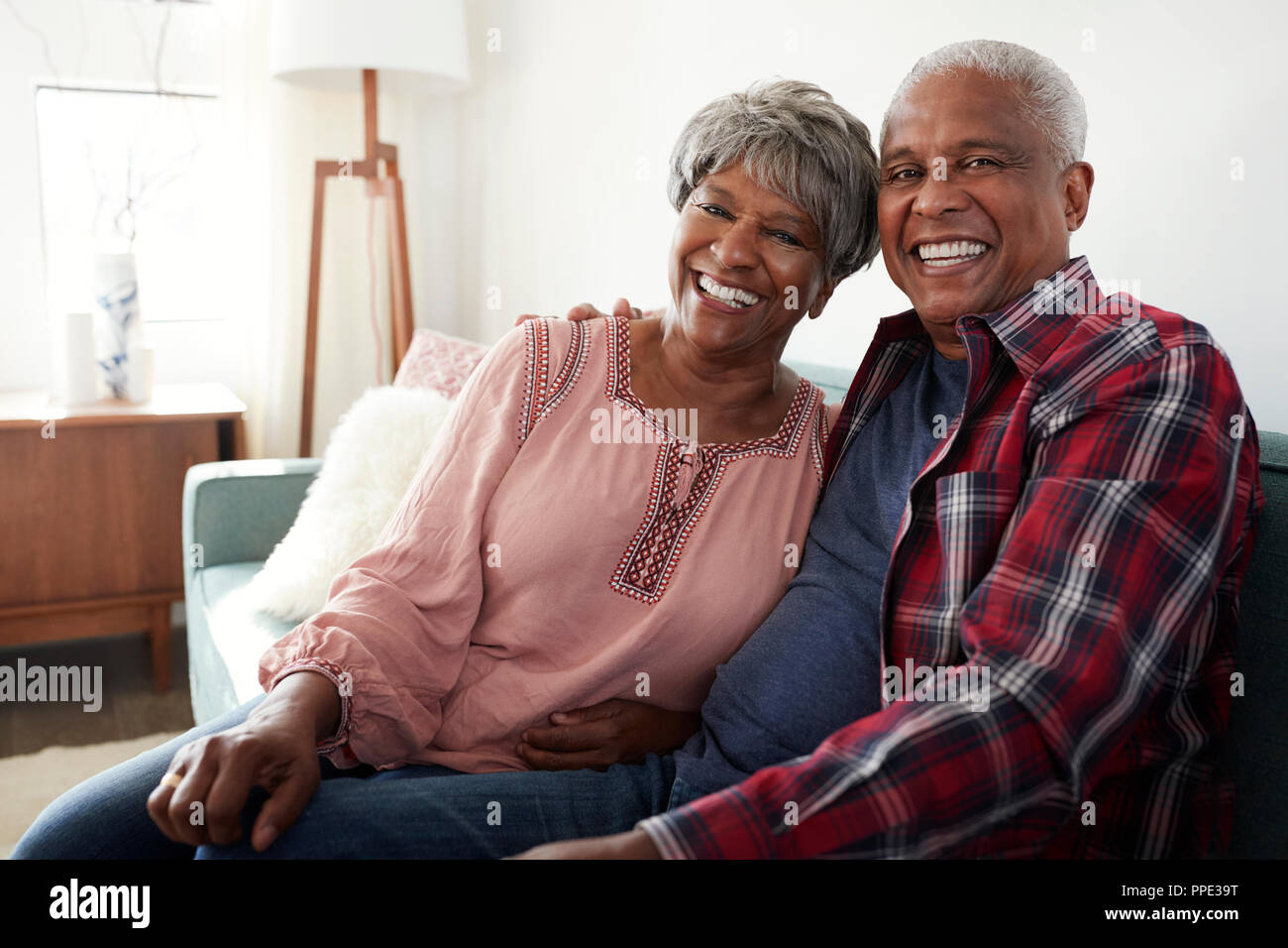 Portrait Of Loving Senior Couple Relaxing On Sofa At Home Stock Photo ...