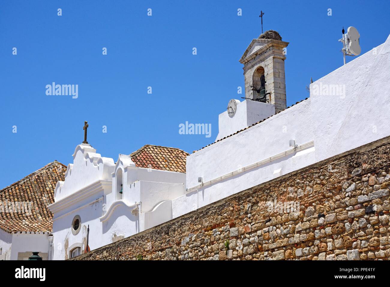 View of the rear of the 19th century city gateway wall and bell tower (Arco da Vila) in the city centre, Faro, Algarve, Portugal, Europe. Stock Photo