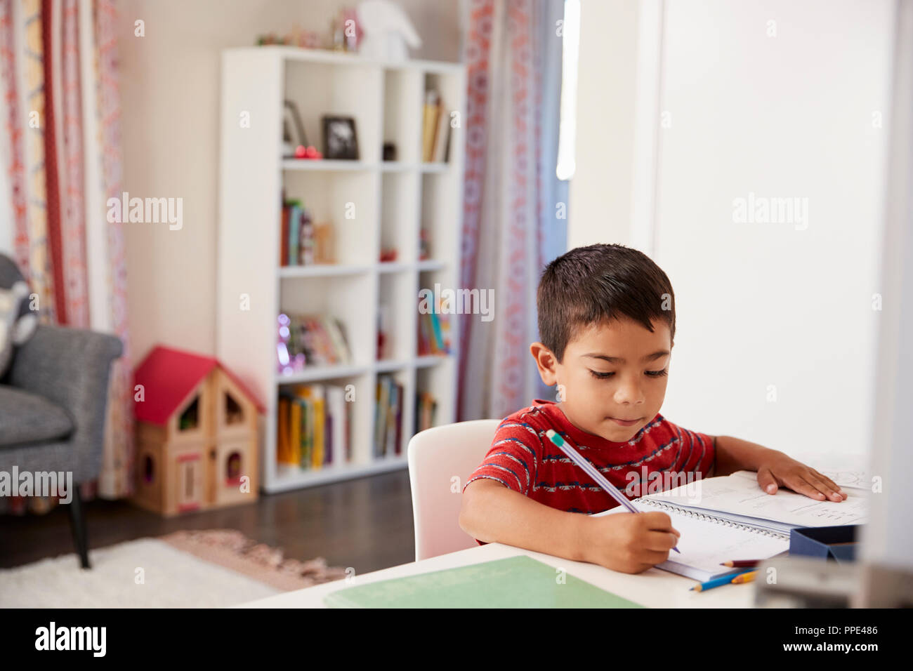 Boy sitting desk in bedroom hires stock photography and images Alamy