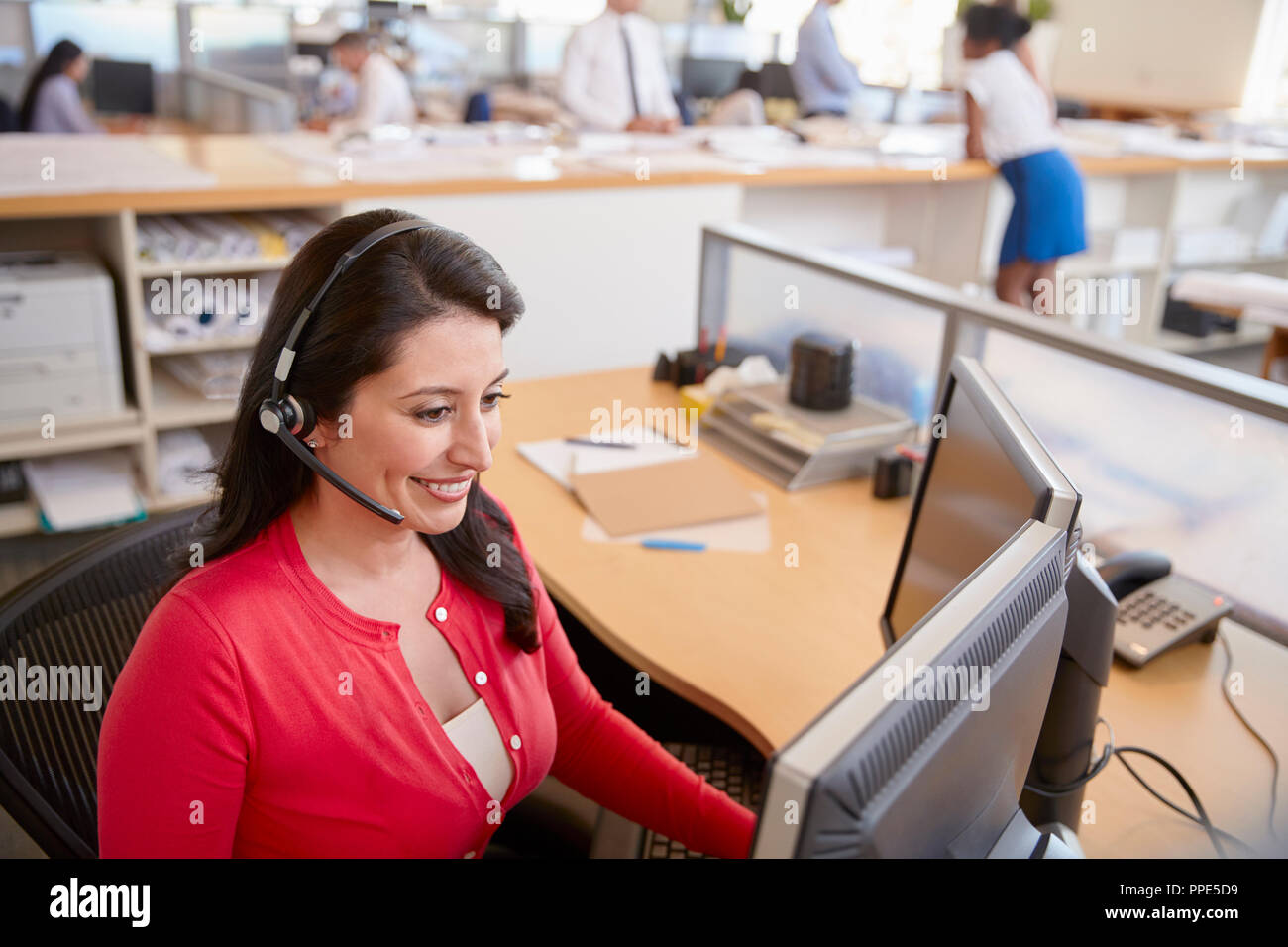 Hispanic woman working in a call centre, elevated view Stock Photo