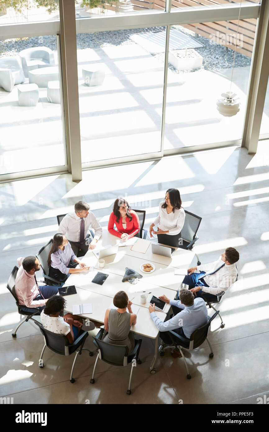 Businesswoman addressing meeting, elevated view, vertical Stock Photo