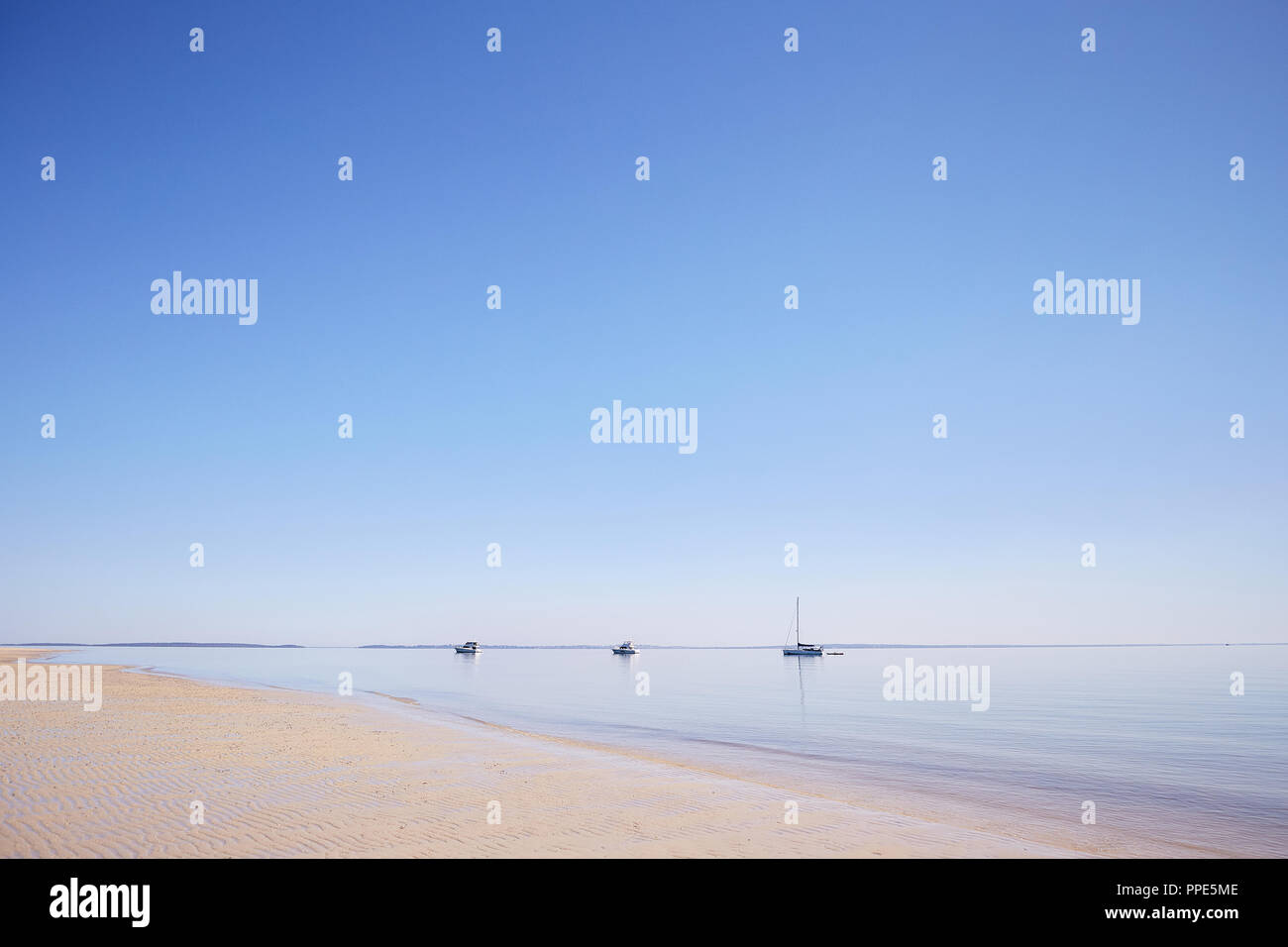 Moored boats in early morning light at Kingfisher Bay, Fraser Island, Queensland Australia Stock Photo